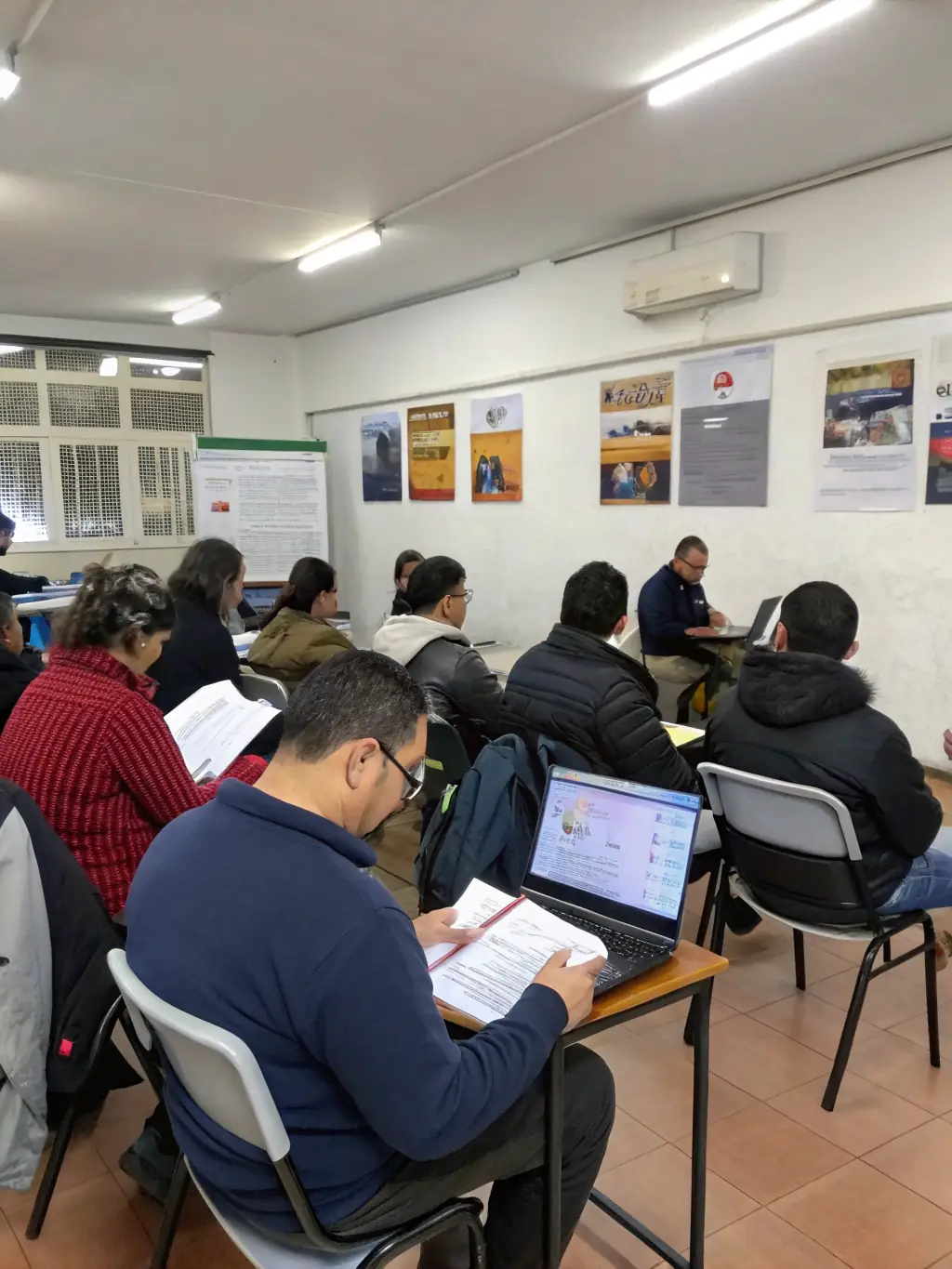 Adults attending a workshop on resume writing and job searching, led by a career counselor in the library's meeting room.